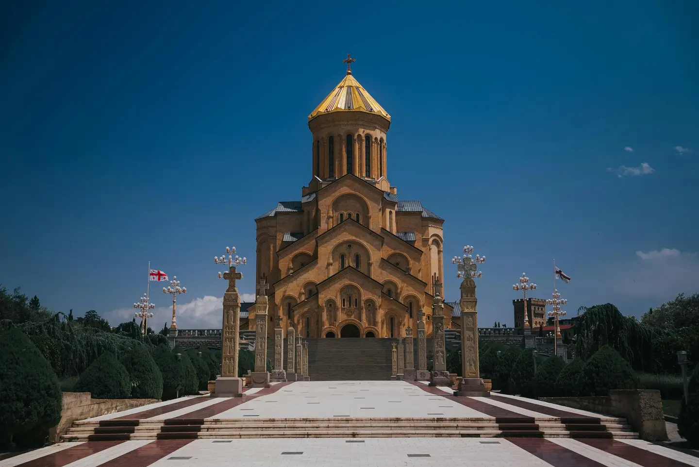 Sameba Cathedral in Tbilisi, Georgia against a clear blue sky