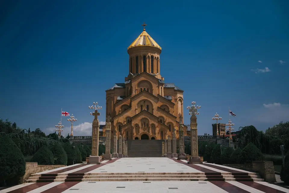 Sameba Cathedral in Tbilisi, Georgia against a clear blue sky
