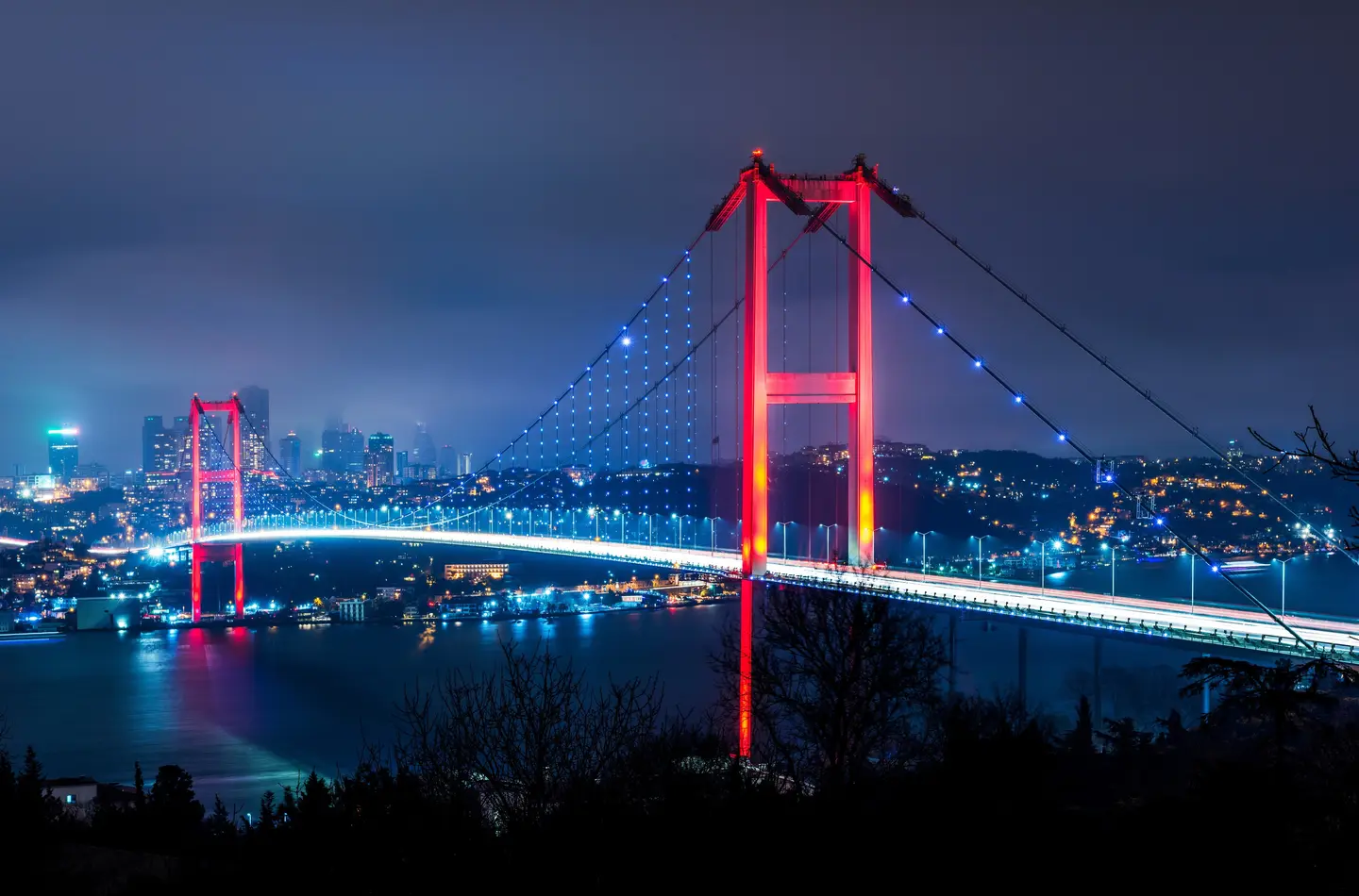 The Bosphorus Bridge lit up at night in Istanbul, Turkey